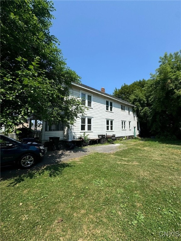 152 Fage Ave Unit 54, Syracuse, NY 13205 - back of house with a lawn and a chimney
