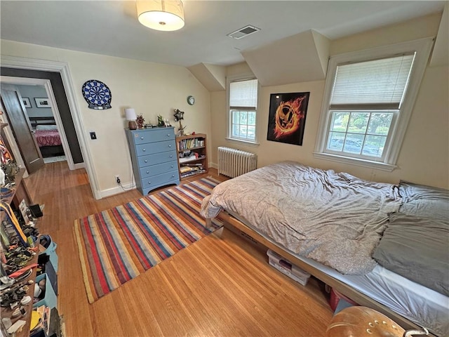 290 Hollywood Ave, Brighton, NY 14618 - bedroom featuring radiator heating unit and wood finished floors