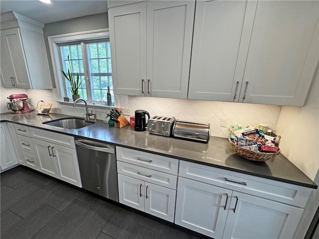 290 Hollywood Ave, Brighton, NY 14618 - kitchen with stainless steel dishwasher, decorative backsplash, dark countertops, white cabinetry, and dark wood-style floors
