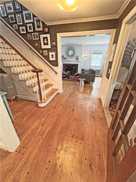 290 Hollywood Ave, Brighton, NY 14618 - hallway featuring ornamental molding, wood-type flooring, and stairway