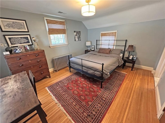 290 Hollywood Ave, Brighton, NY 14618 - bedroom with radiator, light wood-style flooring, and vaulted ceiling