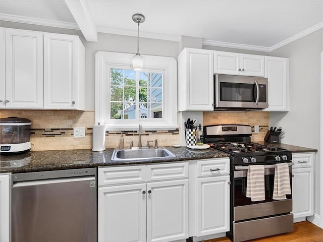 245 Worthington Rd, Irondequoit, NY 14622 - kitchen featuring appliances with stainless steel finishes, white cabinets, decorative backsplash, ornamental molding, and hanging light fixtures