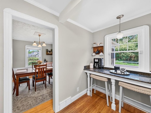 245 Worthington Rd, Irondequoit, NY 14622 - dining area featuring light wood finished floors, ornamental molding, and a chandelier