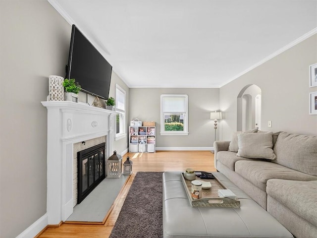 245 Worthington Rd, Irondequoit, NY 14622 - living room featuring wood finished floors, a glass covered fireplace, arched walkways, and ornamental molding
