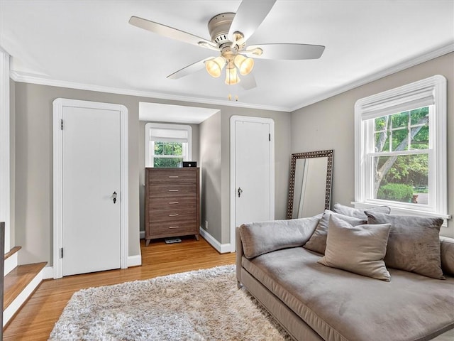 245 Worthington Rd, Irondequoit, NY 14622 - living room featuring a ceiling fan, light wood-style floors, crown molding, and stairs