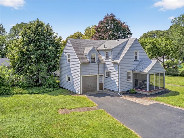 245 Worthington Rd, Irondequoit, NY 14622 - view of front facade featuring a sunroom, a front lawn, driveway, roof with shingles, and a garage