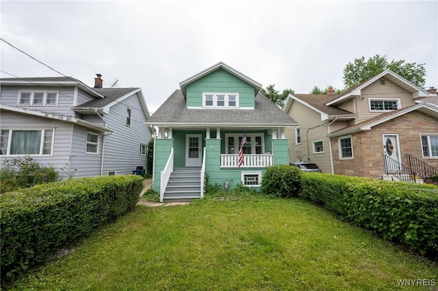 827 Tifft St, Buffalo, NY 14220 - view of front facade with a porch, a front lawn, and roof with shingles