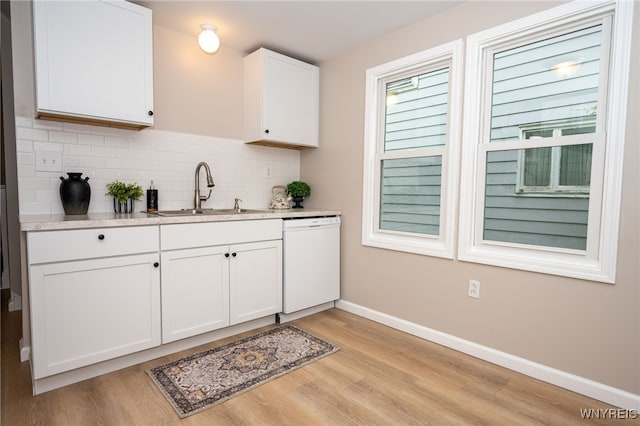 827 Tifft St, Buffalo, NY 14220 - kitchen featuring dishwasher, light wood-style flooring, white cabinetry, tasteful backsplash, and light countertops