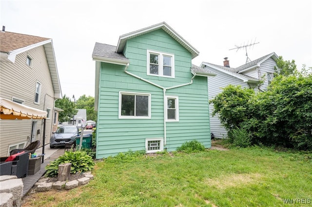 827 Tifft St, Buffalo, NY 14220 - back of house featuring a lawn, an outdoor living space, and a shingled roof