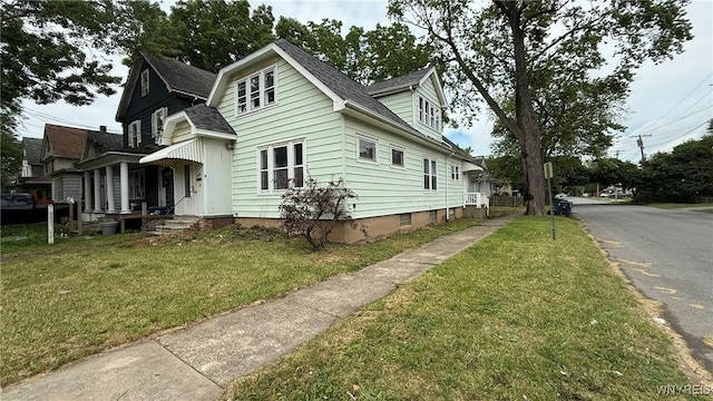 1890 Linwood Ave, Niagara Falls, NY 14305 - view of side of property featuring roof with shingles and a yard
