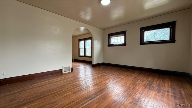 1890 Linwood Ave, Niagara Falls, NY 14305 - empty room with arched walkways and dark wood-style floors