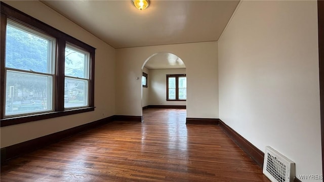 1890 Linwood Ave, Niagara Falls, NY 14305 - spare room with arched walkways and dark wood-style floors