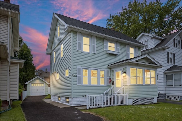 2079 Clifford Ave, Rochester, NY 14609 - view of front facade with asphalt driveway, an outbuilding, a garage, entry steps, and a front yard