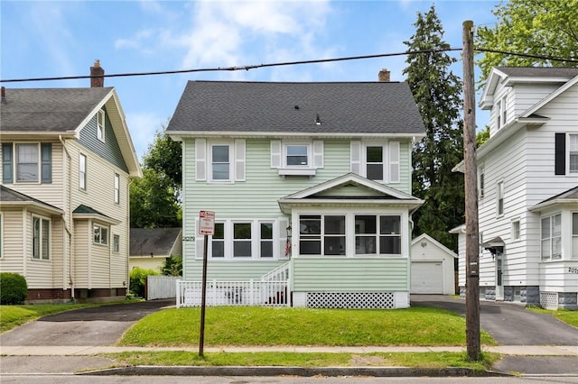 2079 Clifford Ave, Rochester, NY 14609 - view of front of home with an outdoor structure, a chimney, a garage, and a front yard