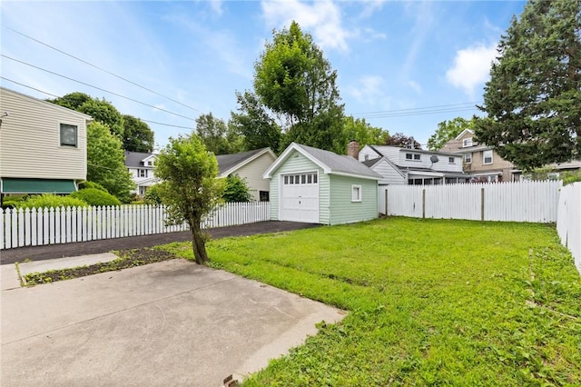2079 Clifford Ave, Rochester, NY 14609 - fenced backyard featuring a detached garage, an outbuilding, a residential view, asphalt driveway, and a patio