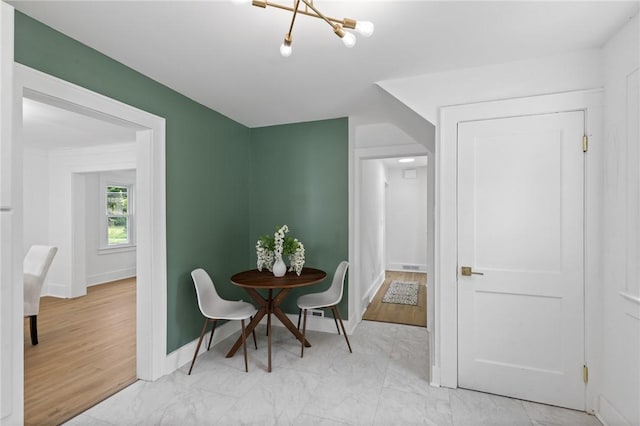 2079 Clifford Ave, Rochester, NY 14609 - dining area with a chandelier and light marble finish flooring