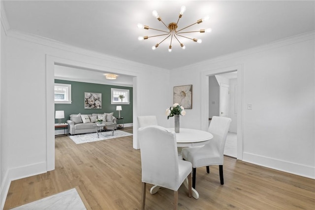 2079 Clifford Ave, Rochester, NY 14609 - dining area with a chandelier, ornamental molding, and light wood-style floors