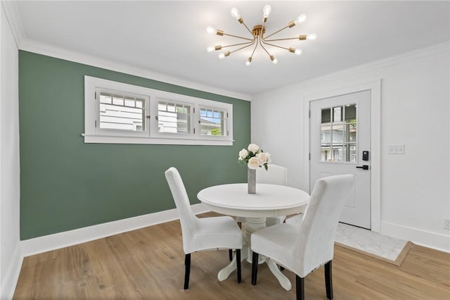2079 Clifford Ave, Rochester, NY 14609 - dining room with crown molding, a chandelier, and wood finished floors
