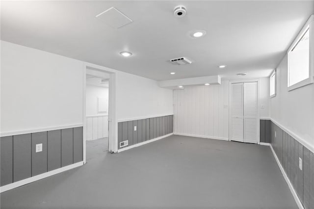 2079 Clifford Ave, Rochester, NY 14609 - spare room with wainscoting, concrete flooring, and recessed lighting