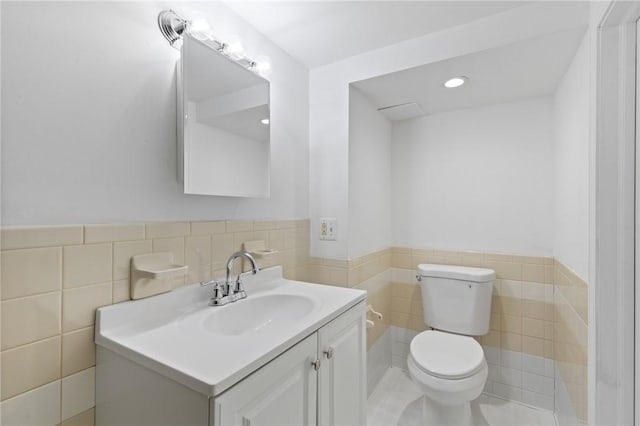 2079 Clifford Ave, Rochester, NY 14609 - bathroom featuring tile walls, vanity, and a wainscoted wall