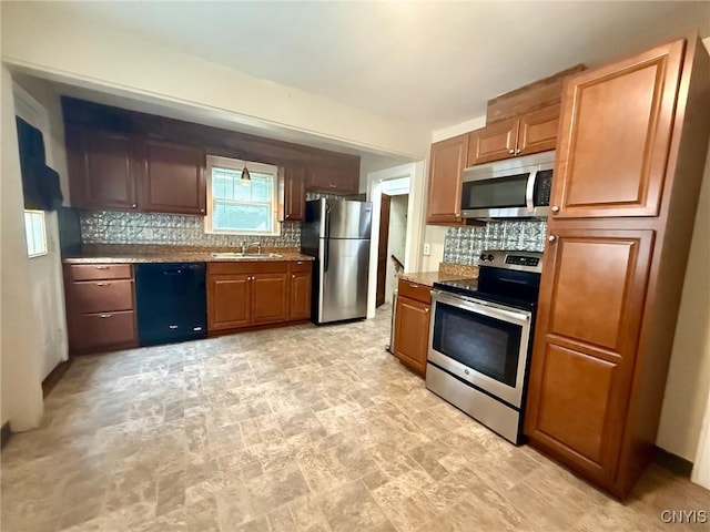 211 Pharis St, Syracuse, NY 13204 - kitchen with stainless steel appliances, decorative backsplash, stone finish flooring, and brown cabinetry