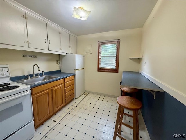 211 Pharis St, Syracuse, NY 13204 - kitchen featuring white appliances, light flooring, dark countertops, brown cabinetry, and white cabinets