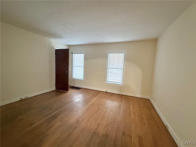 211 Pharis St, Syracuse, NY 13204 - spare room with wood finished floors and baseboards