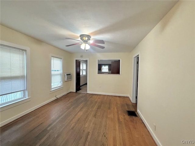 211 Pharis St, Syracuse, NY 13204 - empty room featuring wood finished floors, a ceiling fan, and an AC wall unit