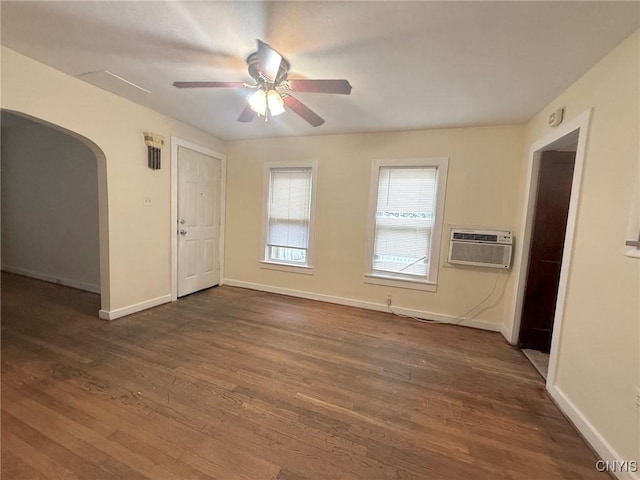 211 Pharis St, Syracuse, NY 13204 - unfurnished room featuring a wall mounted air conditioner, arched walkways, a ceiling fan, and dark wood-style flooring