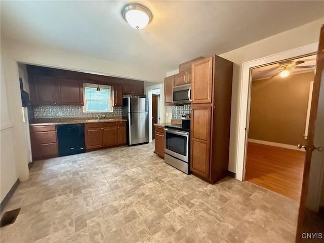 211 Pharis St, Syracuse, NY 13204 - kitchen featuring appliances with stainless steel finishes, tasteful backsplash, ceiling fan, and stone finish flooring