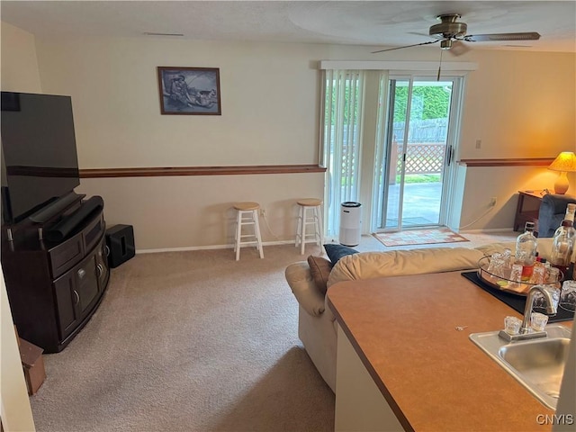 8467 Torchwood Ln, Cicero, NY 13039 - carpeted living area featuring a sink and ceiling fan