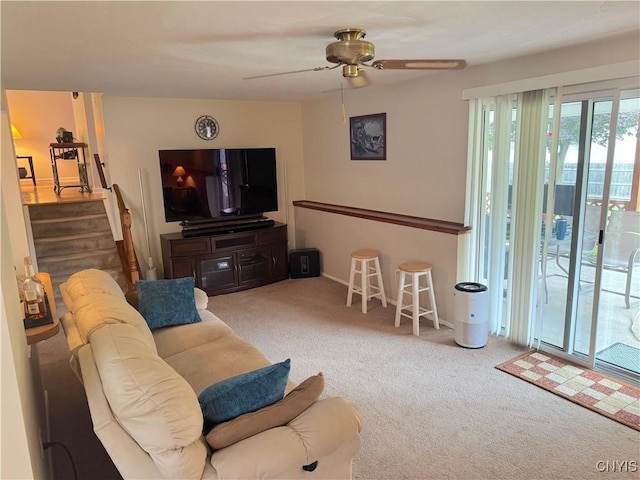8467 Torchwood Ln, Cicero, NY 13039 - carpeted living room featuring a ceiling fan and stairway