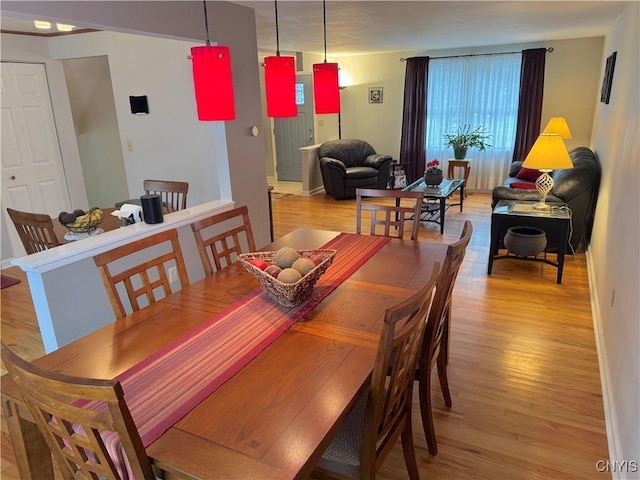 8467 Torchwood Ln, Cicero, NY 13039 - dining area featuring light wood-style flooring and baseboards