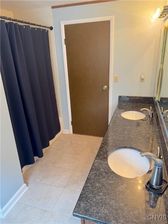 8467 Torchwood Ln, Cicero, NY 13039 - full bath with tile patterned flooring and double vanity