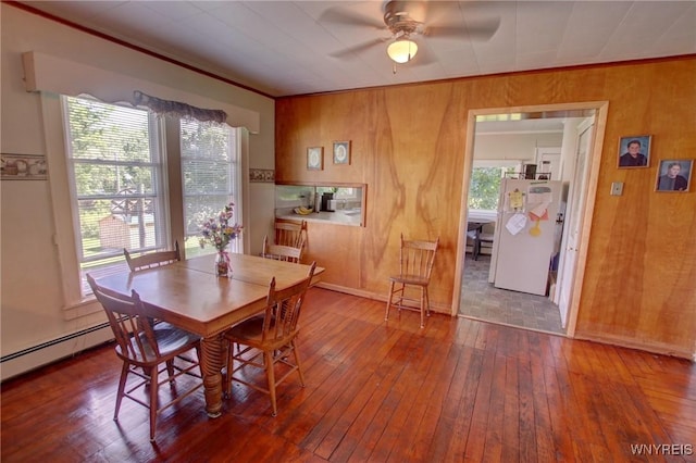 6716 Main St, Cherry Creek, NY 14723 - dining space with a ceiling fan, wood-type flooring, wooden walls, and crown molding