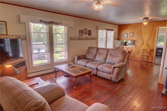6716 Main St, Cherry Creek, NY 14723 - living room with a baseboard heating unit, ceiling fan, hardwood / wood-style flooring, crown molding, and wood walls