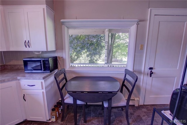 6716 Main St, Cherry Creek, NY 14723 - dining room featuring healthy amount of natural light and a baseboard heating unit