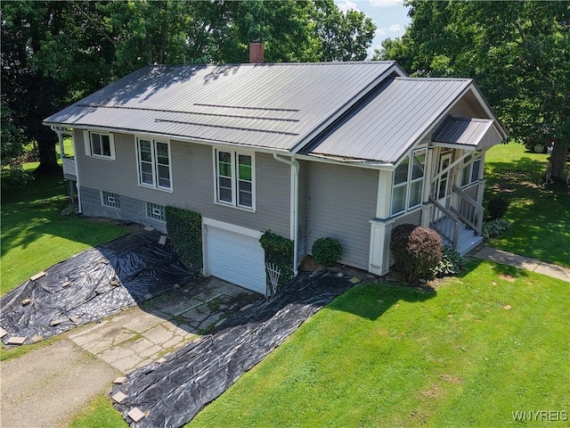 6716 Main St, Cherry Creek, NY 14723 - view of front of home with a garage, asphalt driveway, a chimney, a front lawn, and a metal roof
