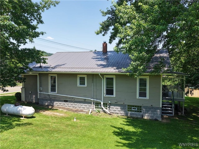 6716 Main St, Cherry Creek, NY 14723 - rear view of house featuring a lawn, a chimney, and a metal roof