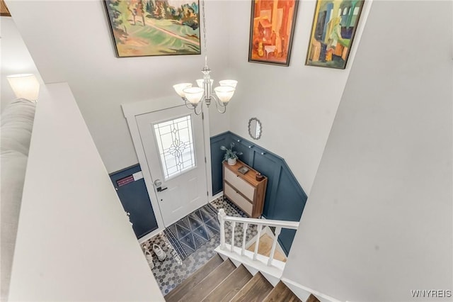 7052 Waring Cir, Evans, NY 14047 - foyer entrance with a chandelier, wood finished floors, and stairway