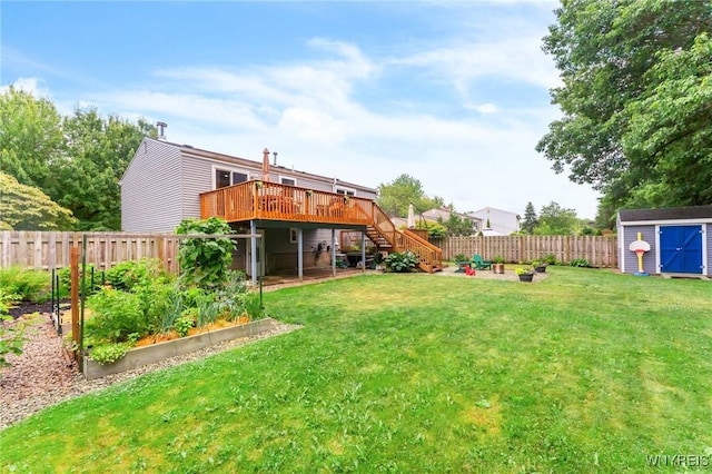 7052 Waring Cir, Evans, NY 14047 - fenced backyard with a garden, a wooden deck, stairway, and a storage unit