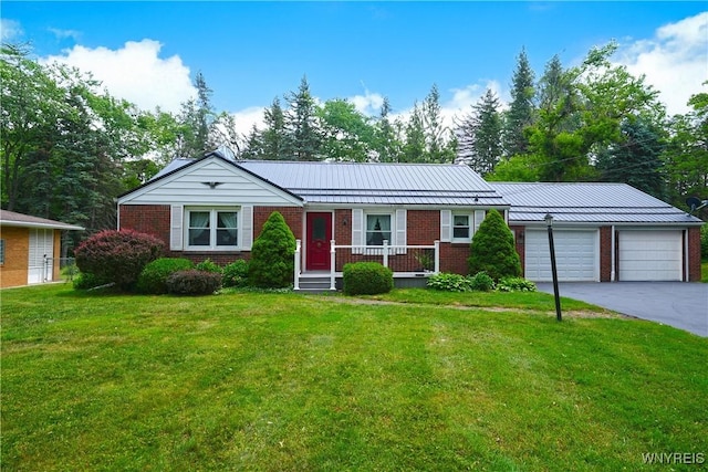 3461 Orchard Park Rd, Orchard Park, NY 14127 - single story home with brick siding, a garage, a standing seam roof, a front yard, and driveway