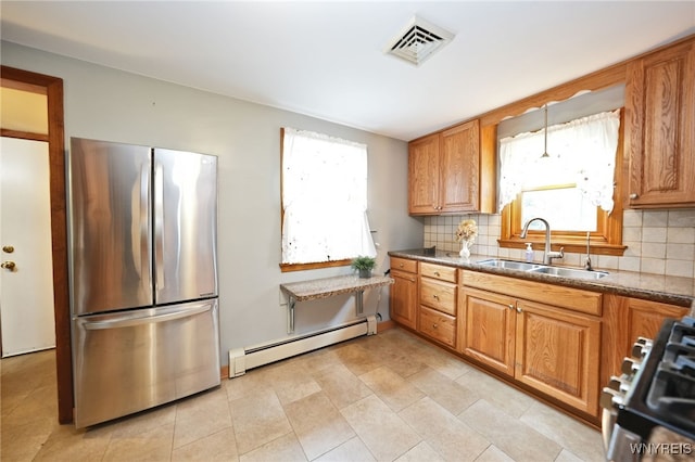 3461 Orchard Park Rd, Orchard Park, NY 14127 - kitchen with freestanding refrigerator, a baseboard radiator, stove, backsplash, and brown cabinets