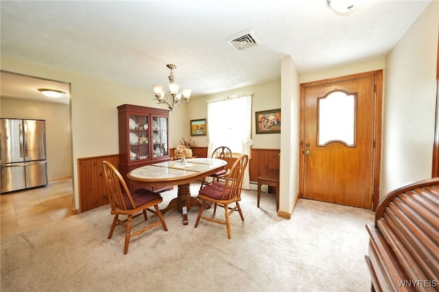 3461 Orchard Park Rd, Orchard Park, NY 14127 - dining area featuring a chandelier, wainscoting, wood walls, light colored carpet, and baseboard heating