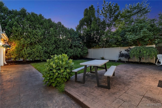 66 Devonshire Rd, Tonawanda, NY 14223 - patio terrace at dusk featuring a patio, a fenced backyard, and outdoor dining area