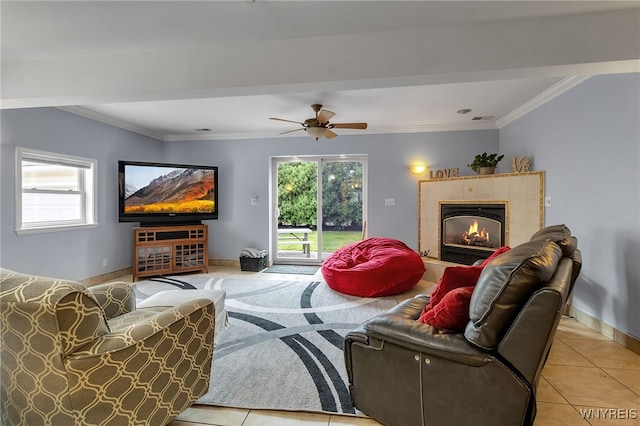 66 Devonshire Rd, Tonawanda, NY 14223 - living room with a tiled fireplace, crown molding, light tile patterned floors, and ceiling fan