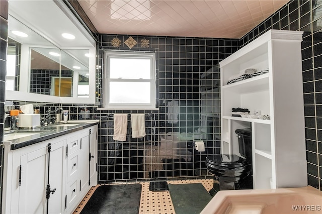 66 Devonshire Rd, Tonawanda, NY 14223 - bathroom with tile walls, double vanity, and tile patterned floors