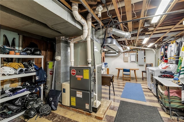 66 Devonshire Rd, Tonawanda, NY 14223 - unfinished below grade area with electric panel, washing machine and dryer, heating unit, and gas water heater
