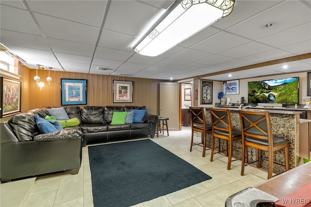 66 Devonshire Rd, Tonawanda, NY 14223 - living room with a drop ceiling, light tile patterned floors, wooden walls, and plenty of natural light