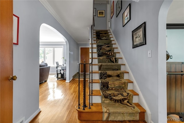66 Devonshire Rd, Tonawanda, NY 14223 - stairs with arched walkways, ornamental molding, and wood finished floors